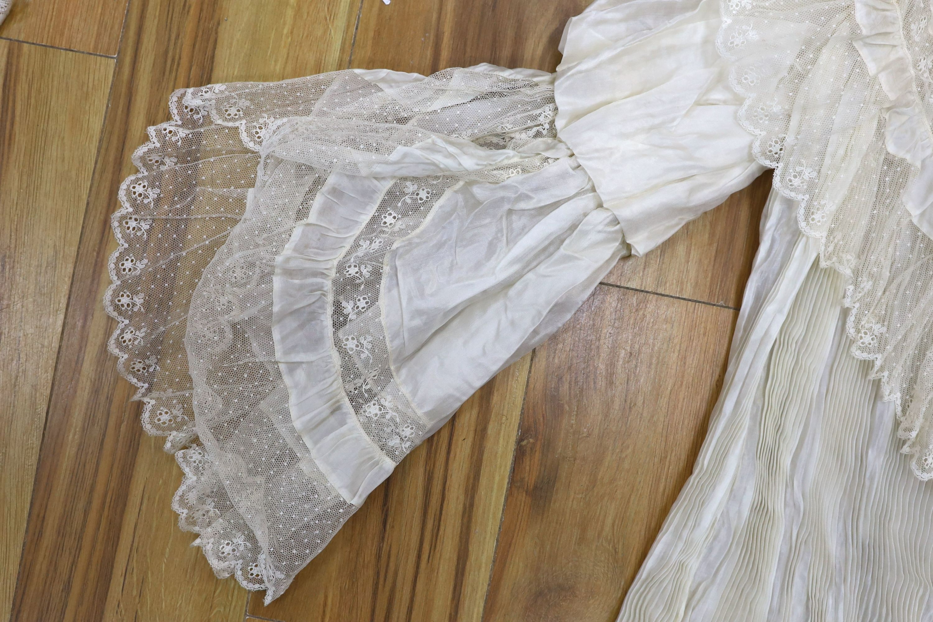 A fine cream silk and lace inserted pleated jacket